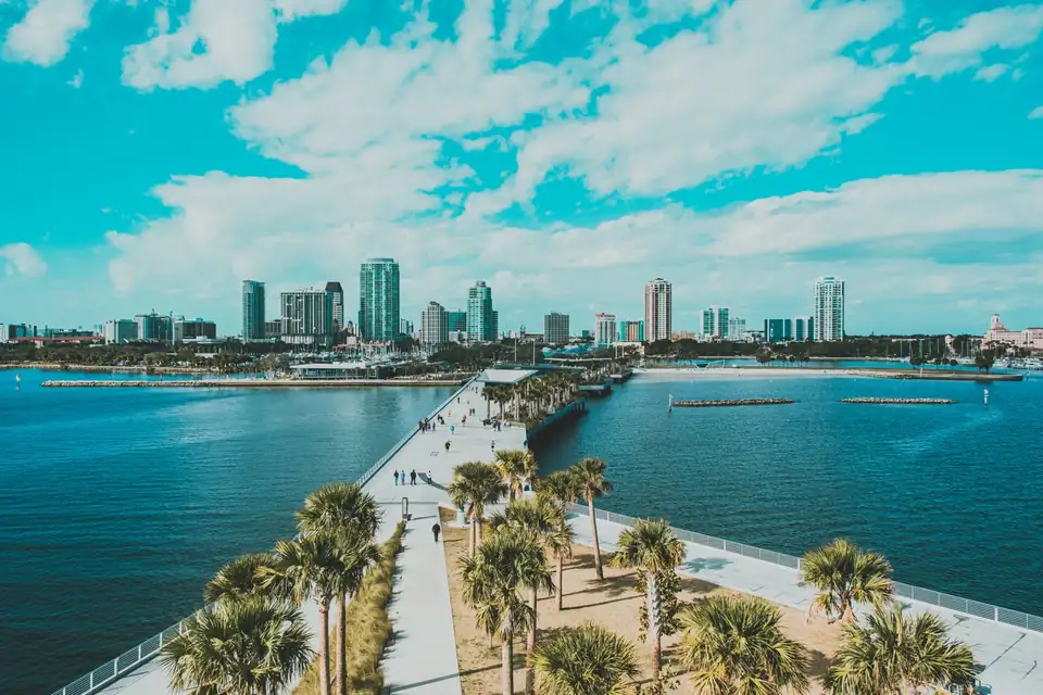 A pier and downtown towers along the water in St. Petersburg.